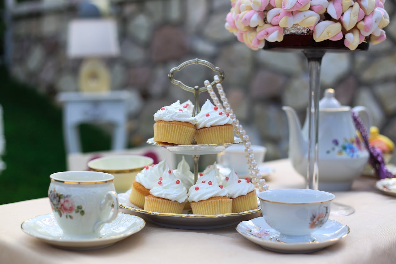 Crafting Captivating Headlines: Your awesome post title goes here Charming tea party setup with cupcakes and porcelain tea set outdoors.