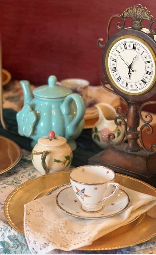 Home Topsy Turvy Mad Hatter tea-party collection with vintage clock, turquoise teapot, and gold place setting